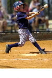 youth player swinging a baseball bat at a pitch